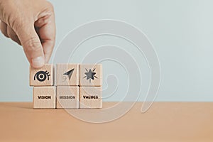 hand arrange mission, vision and values sign and text on wooden cube blocks including copy space. For purpose business, success