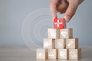 Hand arranging wood block stacking with icon healthcare medical