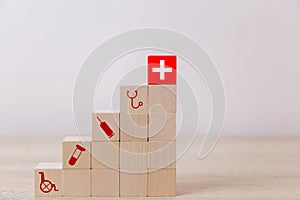 Hand arranging wood block stacking with icon healthcare medical, Insurance for your health concept