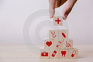 Hand arranging wood block stacking with icon healthcare medical, Insurance for your health concept