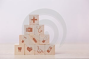 Hand arranging wood block stacking with icon healthcare medical, Insurance for your health concept