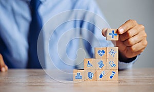 Hand arranging wood block stacking with icon healthcare medical, Insurance for your health medical, Insurance for your health