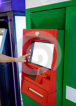 Hand of Asian woman pressing button on ATM machine.