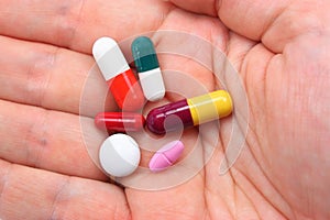 Hand with assorted pills