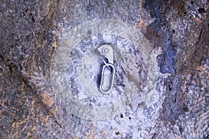 Hand attaching carabiner on rock