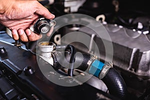 Hand of auto mechanic technician service check cooling water