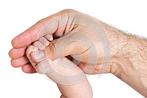Hand of baby holding parent's thumb