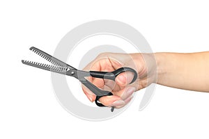 The hand of a Barber holding a scissors for thinning out hair on