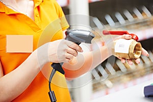 Hand with barcode scanner in shop