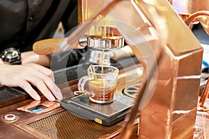 Hand of Barista making coffee with the coffee machine in the coffee shop or cafe, Foods and drink concept. Warm Tone