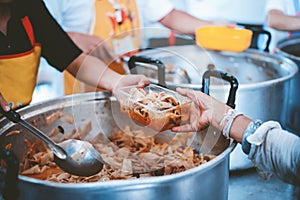 The hand of a beggar receives food from the donor: Donate food to hungry people