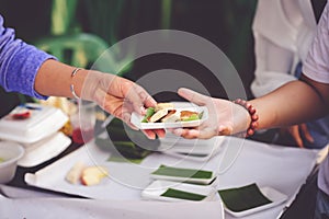 The hand of a beggar receives food from the donor: Donate food to hungry people