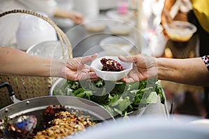 Hand begging for food from the rich`s share : The beggar is waiting for food from charity aid : the concept of begging and hunger