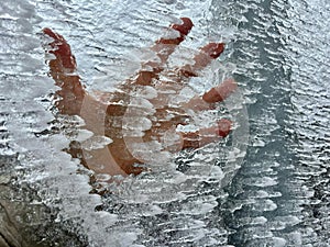 A hand behind the ice surface, cold day in Teide National Park, Tenerife, Canary Islands, Spain