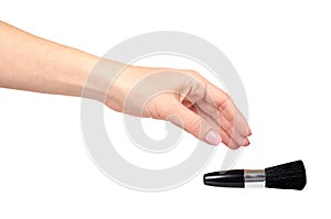 Hand with black eye makeup brush. Isolated