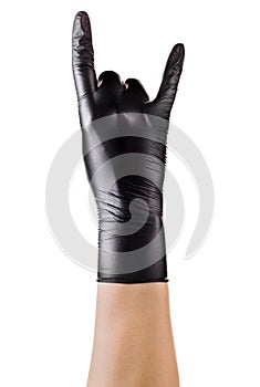 Hand in black gloves showing rock n roll sign or giving the devil horns gesture