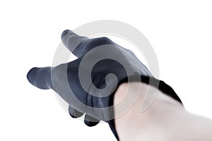 Hand in black latex protective glove pointing at something with a finger away from the camera, gesture closeup, isolated on white