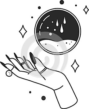 Hand with black nails and rings showing a crystal ball with falling drops and sparkles, predicting the future with esoteric arts photo