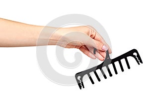 Hand with black plastic clothes hanger. Isolated background