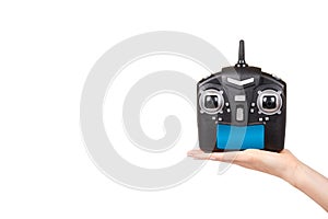 Hand with black remote control for drone, RC with antenna