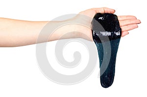 Hand with black slime toy for kids, glitters and goo