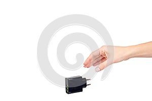 Hand with black USB wall chrger plug, three ports