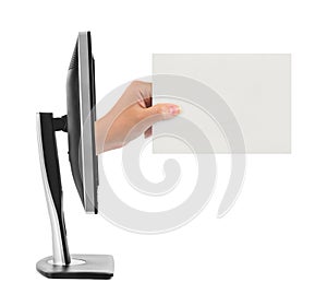 Hand with blank card and computer monitor