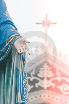 Hand of The Blessed Virgin Mary statue standing in front of The Roman Catholic Diocese that is public place.