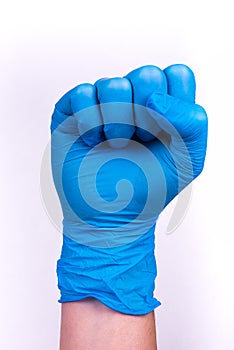 Hand in blue glove in a fist scat