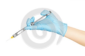 Hand in blue glove holding dental tool