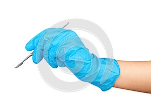 Hand in blue glove holding dental tool