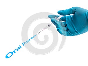 Hand in a blue glove holding syringe with Oral Polio vaccine tex