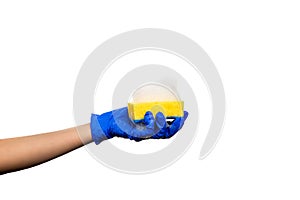 Hand in a blue glove with a yellow sponge and soapy foam