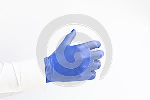Hand in blue latex Glove grabing