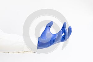 Hand in blue latex Glove grabing. Copy space