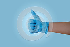 Hand with blue latex glove photo