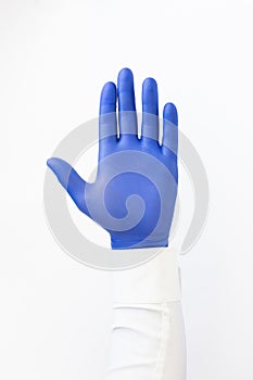 Hand in blue latex Glove. Stop sign. White background