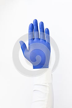 Hand in blue latex Glove. Stop sign. White background