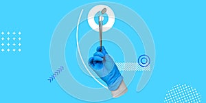 Hand in blue medical glove holds a dental instruments on a light blue background. Dental mirror and probe hook in