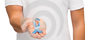 Hand with blue prostate cancer awareness ribbon