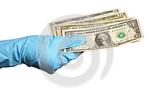 Hand in blue protective gloves with money