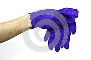 Hand in a blue protective surgical glove shivers blue gloves on the white background