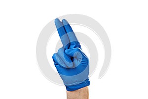 Hand in blue rubber glove showing gesture symbol, on white isolate
