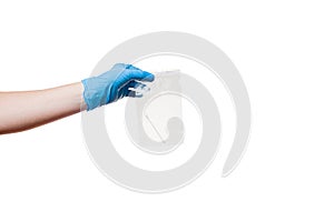 A hand in a blue sterile glove holds an airtight bag with a cotton swab.