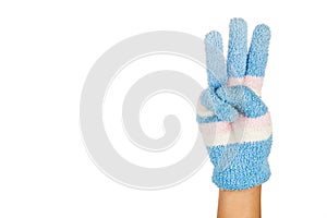 Hand in blue winter glove gesture number three against white bac