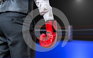 Hand of boxing businessman in box ring