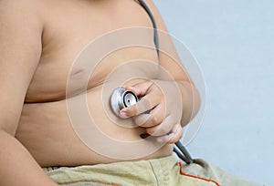 Hand boy check stomach by stethoscope