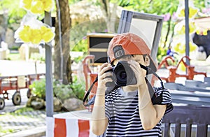 Hand boy holding the camera Taking pictures in park