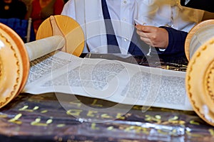 Hand of boy reading the Jewish Torah at Bar Mitzvah