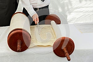 Hand of boy reading the Jewish Torah at Bar Mitzvah 5 SEPTEMBER 2016 USA